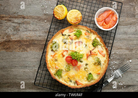 Tasty salmon quiche on cooling rack Stock Photo