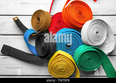 Colorful karate belts on wooden background Stock Photo