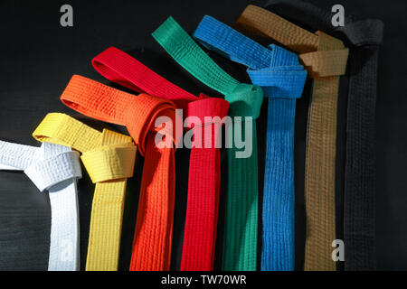 Colorful karate belts on dark background Stock Photo