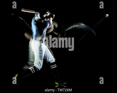 one caucasian baseball player man  studio shot isolated on black background with light painting speed effect Stock Photo