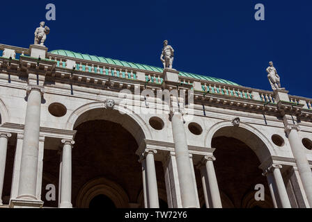 Wonderful Basilica Palladiana marble arches and statues (16th-17th century) in Vicenza with blue sky, designed by the famous renaissance architect And Stock Photo