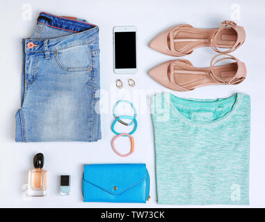 Composition with clothes and accessories on white background Stock Photo