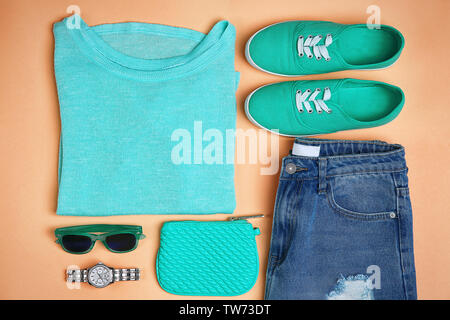 Composition with mint clothes and accessories on apricot background Stock Photo