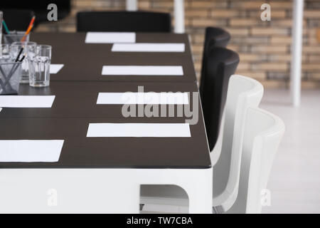 Big table with sheets of paper, indoors Stock Photo