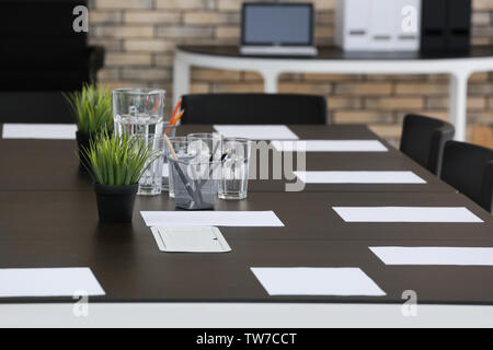 Big table with sheets of paper, indoors Stock Photo