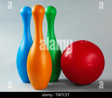 Bright bowling pins and ball on light background Stock Photo