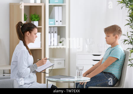Overweight boy at nutritionist's office Stock Photo