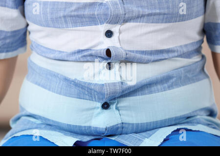 Overweight boy in tight shirt, closeup Stock Photo