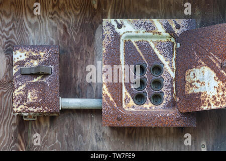 Rusting and exposed former electrical fuse panel on a heritage building at the Britannia Ship Yard in Steveston British Columbia Stock Photo