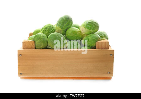 Fresh Brussels sprouts in wooden box on white background Stock Photo