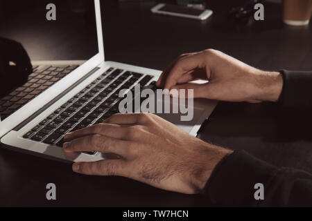 Man hacking server in dark room Stock Photo