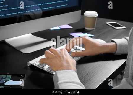 Man hacking server at table Stock Photo