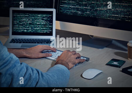 Man hacking server in dark room Stock Photo
