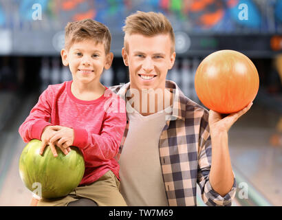 Family having fun in bowling club Stock Photo