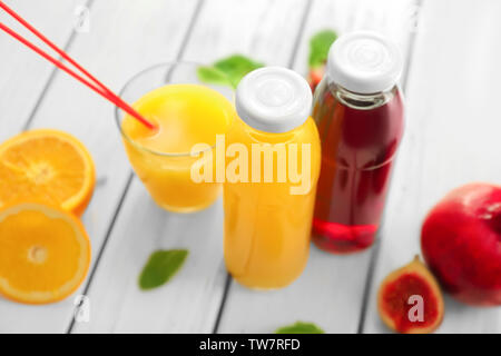 Bottles with fresh juices on table Stock Photo