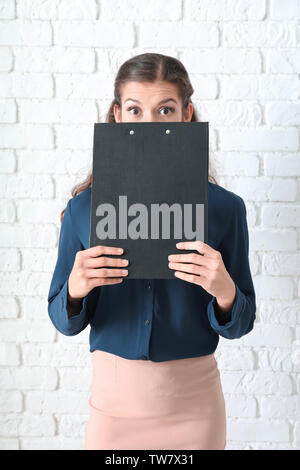 Young manager on brick wall background Stock Photo