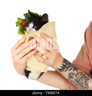 Woman holding little funny kitten in lavash on white background Stock Photo