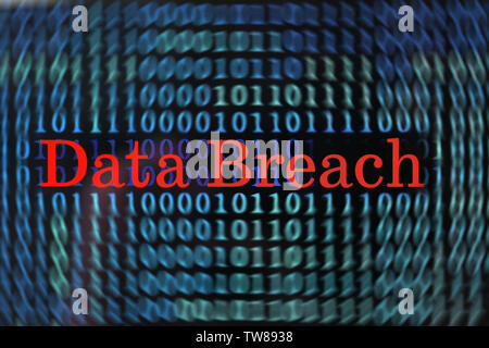 Words "Data breach" with binary code on screen Stock Photo