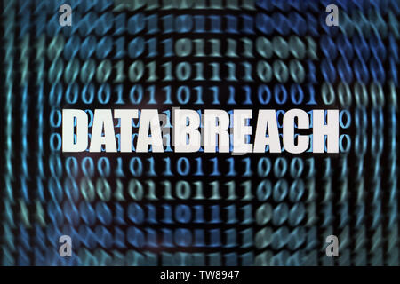 Words "Data breach" with binary code on screen Stock Photo
