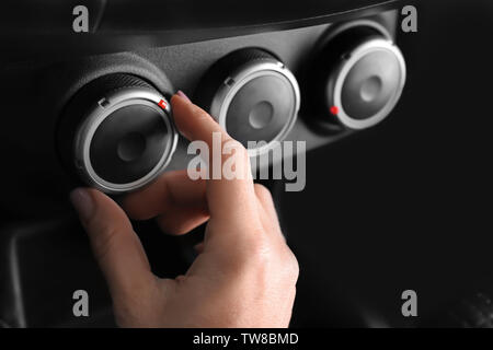 Woman adjusting air conditioner in car, closeup Stock Photo