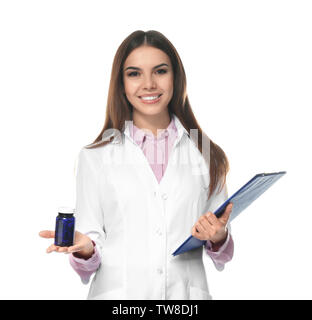 Young female pharmacist with medicament and clipboard on white background Stock Photo