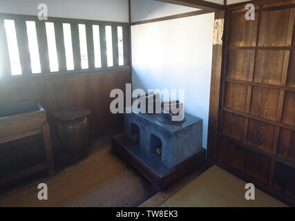 Kitchenette in traditional Japanese Edo period historic building interior. Stove in a small lit with sunlight kitchen of Takayama Jinya house, Takayam Stock Photo