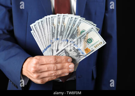 Businessman holding money, closeup. Corruption concept Stock Photo