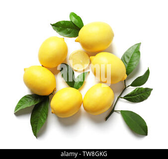 Composition with lemons and green leaves on white background Stock Photo