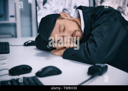 Male security guard sleeping at workplace Stock Photo