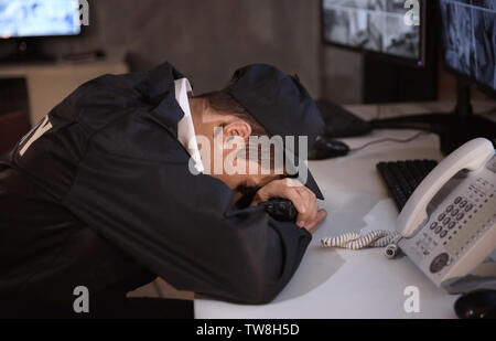 Male security guard sleeping at workplace Stock Photo