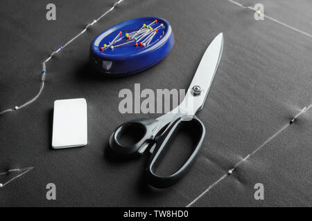 Tailoring scissors, chalk and pins on fabric Stock Photo