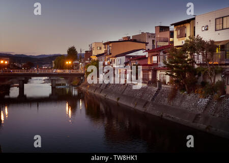 Row of houses on a bank of Miyagawa river, Takayama in a sunset city scenery. Hida-Takayama, Gifu prefecture, Japan 2018. Stock Photo