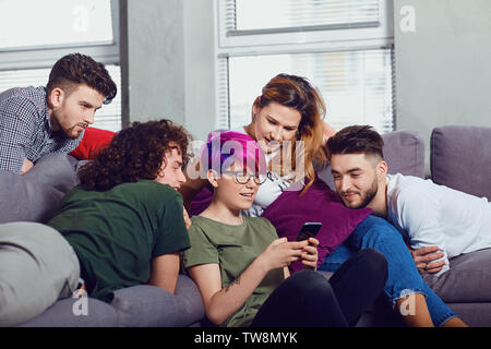 A group of friends at a meeting talking together in the room. Stock Photo