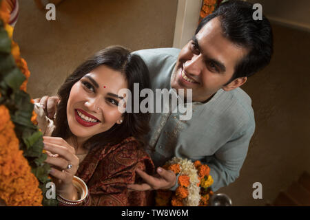 Young couple newlywed in traditional dress performing rituals Stock Photo