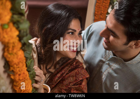 Young couple newlywed in traditional dress performing rituals Stock Photo