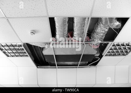 Industrial air conditioner mounted on ceiling indoors Stock Photo