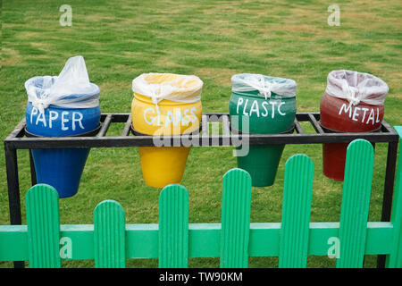 Different colorful trash bins outdoors. Recycling concept Stock Photo