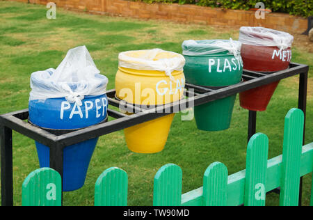 Different colorful trash bins outdoors. Recycling concept Stock Photo
