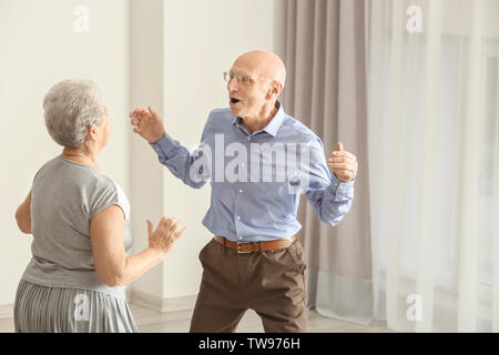 Cute elderly couple dancing at home Stock Photo