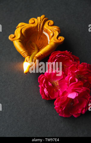 High angle view of a burning diwali diya with flowers Stock Photo