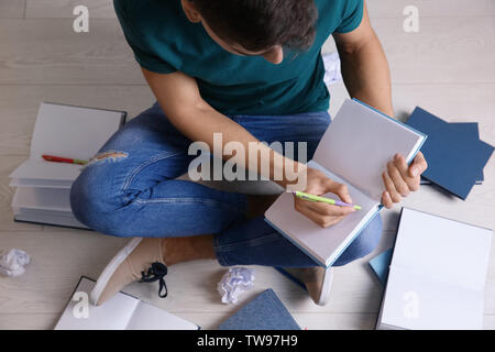 Male student preparing for exam indoors Stock Photo
