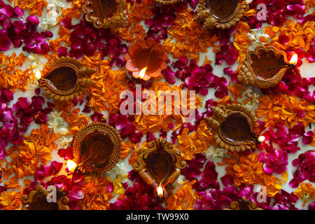 High angle view of a colorful rangoli with oil lamps Stock Photo