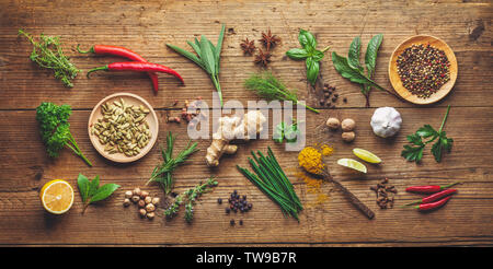 composition of various herbs and spices on wooden background Stock Photo