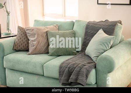 Comfortable mint couch with cushions in living room Stock Photo Alamy