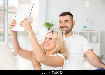 Happy smiling couple taking selfie at home Stock Photo