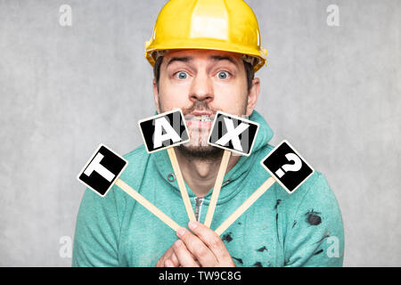 construction worker holding a blackboard with space for text or text, copy space, Stock Photo