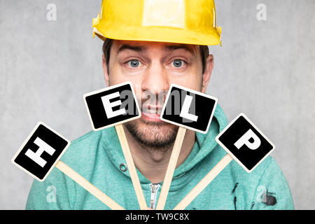 construction worker holding a blackboard with space for text or text, copy space, Stock Photo