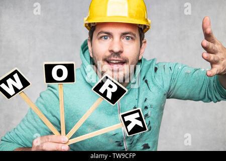 construction worker holding a blackboard with space for text or text, copy space, Stock Photo