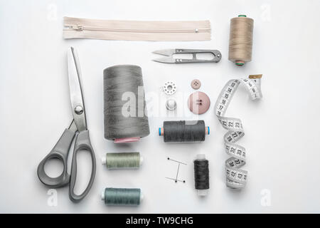 Different threads and sewing accessories on white background Stock Photo