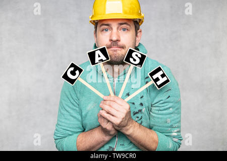 construction worker holding a blackboard with space for text or text, copy space, Stock Photo